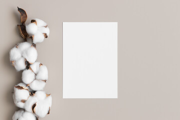 White invitation card mockup with a dried cotton branch. 5x7 ratio, similar to A6, A5.