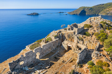 Fototapeta na wymiar morning light on the ruins of antique city on the top of island at the Mediterranean sea with copy space