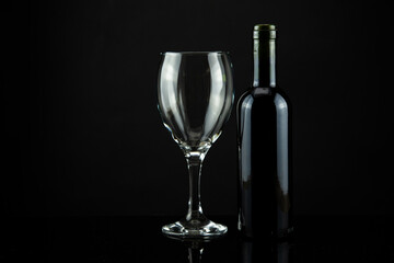 wine bottle and glass, black background
