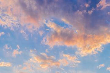 cloudscape in late day sky, golden sunlight reflecting in nuves