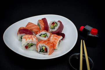 sushi with chopsticks, home delivery service, Rainbow roll with tuna, salmon and shrimp