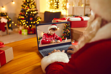 Santa Claus video calling little boy or using spying magic to see if kids are naughty or nice