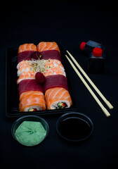 sushi with chopsticks, home delivery service, Rainbow roll with tuna, salmon and shrimp