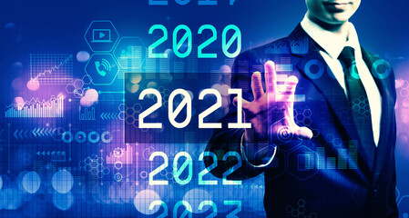 Fototapeta na wymiar 2021 New Year concept with businessman on blurred blue light background