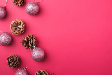 Christmas New Year composition. Gifts, fir tree cones, silver ball decorations on pink background. Winter holidays concept. Flat lay, top view, copy space