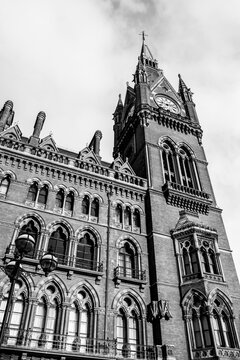 Black and white image of the clock tower at a station in London 