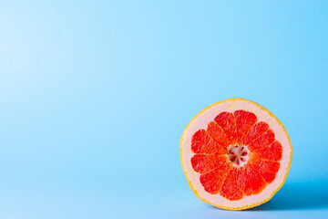 Grapefruit on a blue background. Exotic fruit for diet.