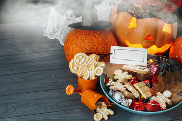 candy bowl of chocolates and sweets, Halloween Jack o Lantern cookies - fresh halloween pumpkin, gourd, squash Trick or Treat Halloween card background