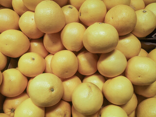 Fresh ripe oranges in a shop window, store counter or supermarket