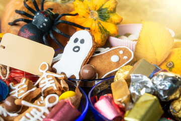 candy bowl of chocolates and sweets, Halloween Jack o Lantern cookies - fresh halloween pumpkin, gourd, squash Trick or Treat Halloween card background