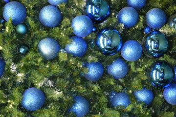 new year decorations shiny blue balls on christmas tree background