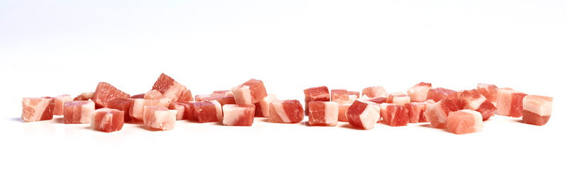 Smoked bacon cubes on kitchen counter, isolated on white background.