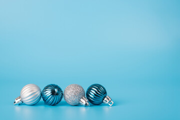 Close up photo of line of different color christmas balls isolated on pastel color background
