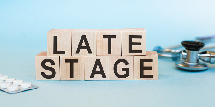 Medical concept photo showing text - late stage - on wooden cubes. Indicates the advanced stage of a disease