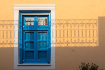 Architecture of Oia town with blue doors on Santorini , Greece