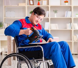 Disabled man working with handsaw at home