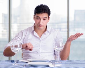 Handsome man alone in restaraunt on date