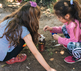 little girls playing with mud