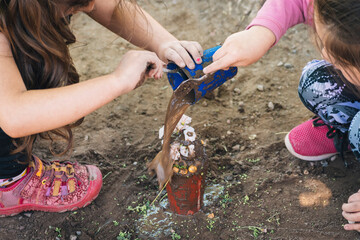 little girls playing with mud