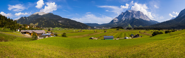 Panorama of Tiroler Zugspitz Arena with Zugspitze Mountain in background, sunny autumn day
