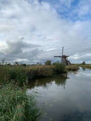 Old Dutch windmills next to the canal used for water management network. Unesco world heritage. Kinderdijk, South Holland / Netherlands 