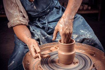 Craftsman master making ceramic pot on the pottery wheel . Concept for woman in freelance, business, hobby. Close-up.