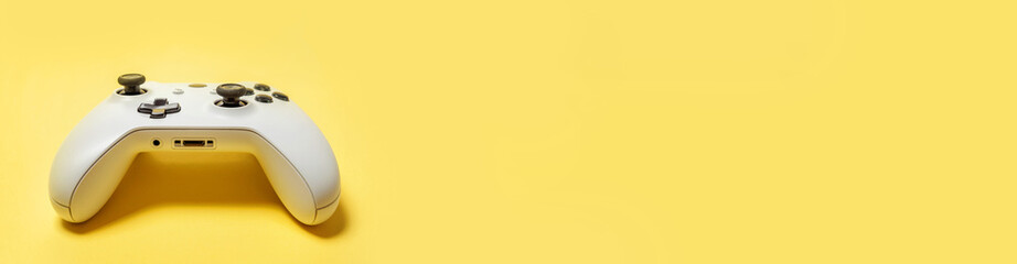 White joystick gamepad game console isolated on yellow colourful trendy background. Computer gaming competition videogame control confrontation concept. Cyberspace symbol Banner © Юлия Завалишина