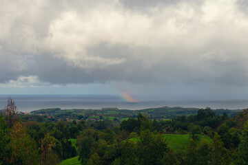 Panoramic view of the Cantabrian Sea with a rainbow over the sea. Cantabria landscape
