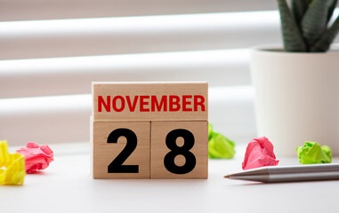 Vintage photo, November 28th. Date of 28 November on wooden cube calendar, copy space for text on...