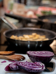 Preparing a vegan Asian Pad Thai stir fry with red cabbage, tofu and noodles. 