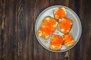 delicacy product red salmon caviar flat lay top view with copy space text on wooden table, healthy organic eco food concept