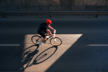 Blurred person riding a bike in the city