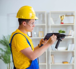 Young repairman with power drill