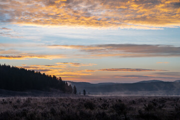 Colorful sunrise in Hayden Valley, with steam coming up from the Yellowstone River