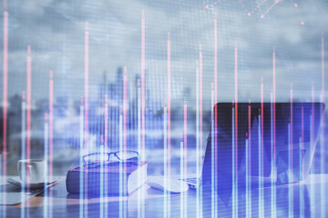 Double exposure of financial chart drawings and desk with open notebook background. Concept of forex market