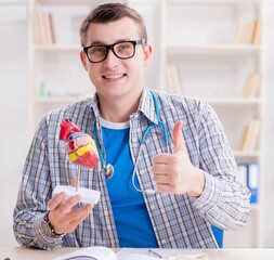 Medical student studying heart in classroom during lecture