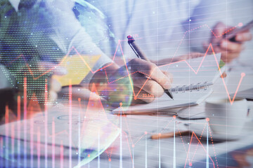 Double exposure of forex graph drawing over people taking notes background. Concept of financial analysis