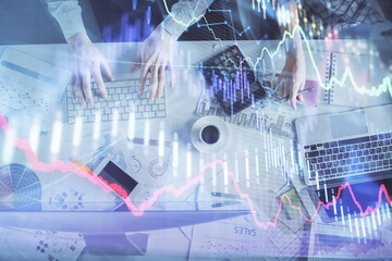 Double exposure of man and woman working together and financial chart hologram drawing. market analysis concept. Computer background. Top View.