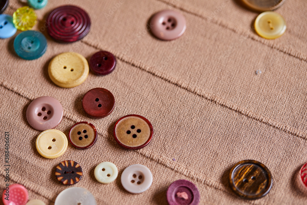 Poster background and texture of multicolored antique buttons and sewing tools