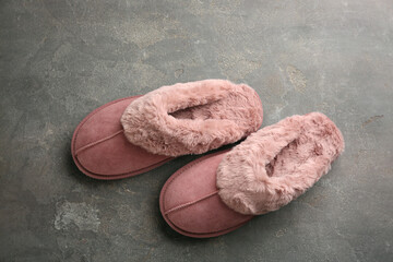 Fototapeta na wymiar Pair of stylish soft slippers on grey background, flat lay