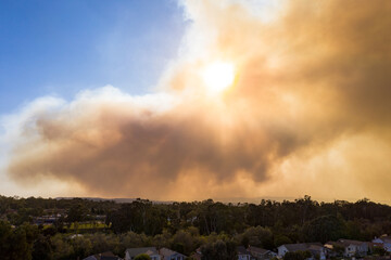 Naklejka na ściany i meble Aerial View of Orange County California Wildfire Smoke Covering Middleclass Neighborhoods During the Silverado Fire_10