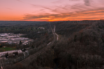 Sunset on a Mountain with Panoramic view below and vibrant sky colours