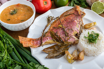 Roasted red fish (Olho de Cão in Brazil) seasoned with herbs, garlic, salt and lemon. Accompanying...