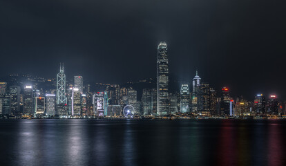 Fototapeta na wymiar Hong Kong Harbourfront Cityscape Skyling in the Night Time with Vibrant Buildings and Skyscrapers