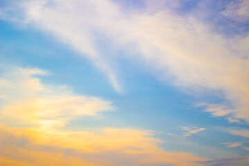 Naklejka na ściany i meble Blue sky in autumn with the sun shining on fluffy clouds.