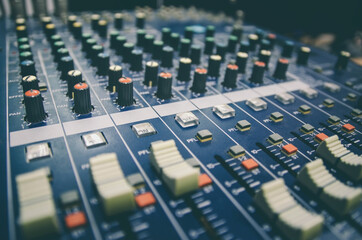 Audio mixer console and professional sound mixing with buttons and sliders.