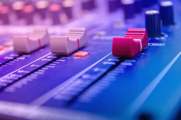 Audio mixer console and professional sound mixing with buttons and sliders.