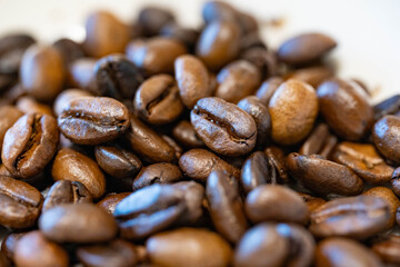 roasted coffee beans are on a table.