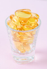 Fish oil capsules in glass.
