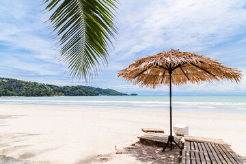Fototapeta na wymiar Beach Umbrella made of palm leafs on a perfect white beach in front of Sea, Thailand.